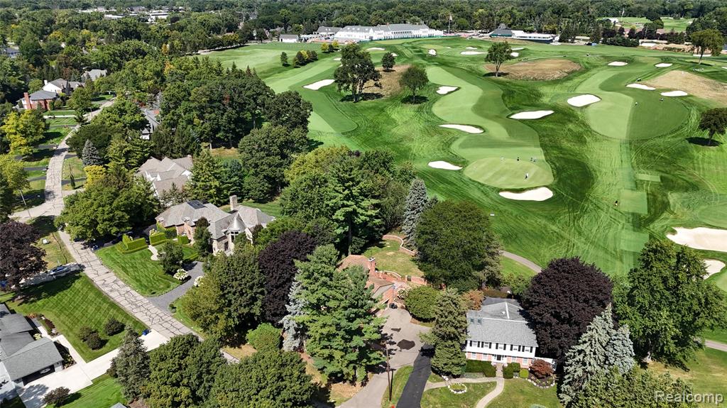 Surrounding community with view of golf course and a water view