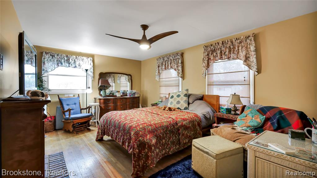 Bedroom with hardwood / wood-style flooring and a ceiling fan