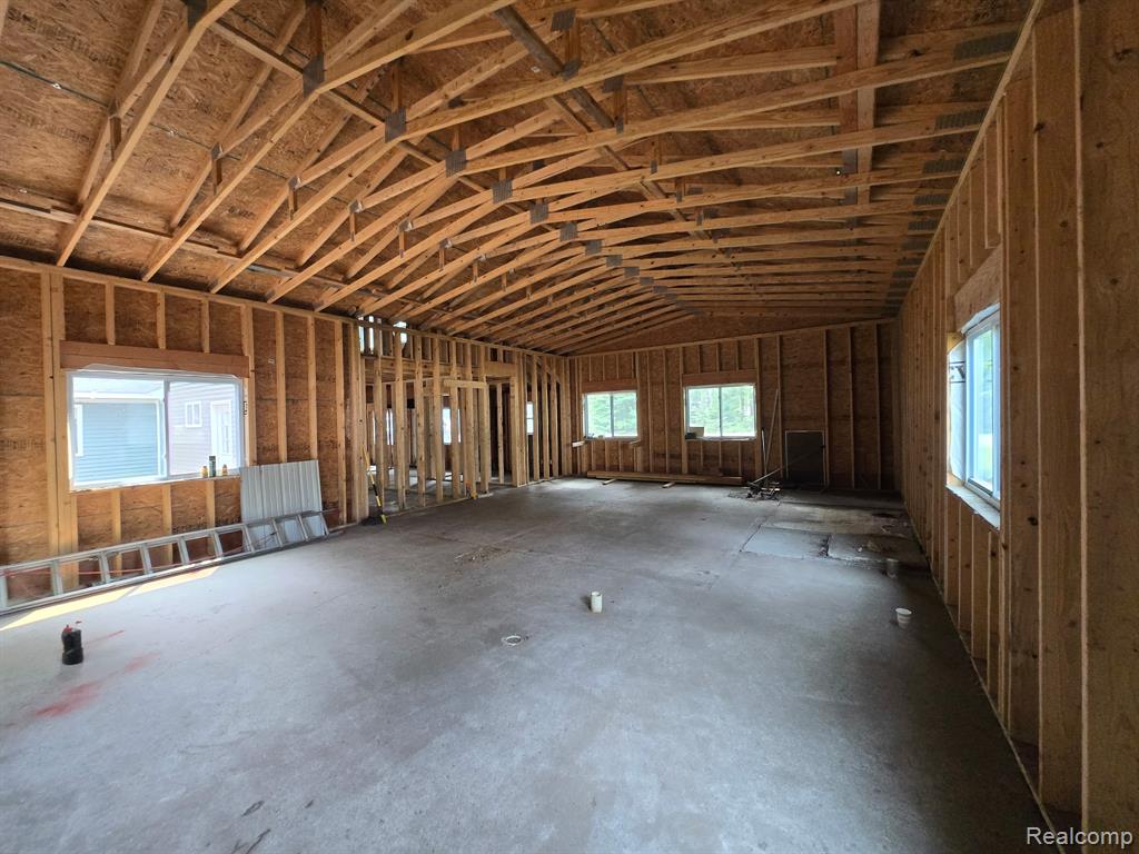 Miscellaneous room featuring lofted ceiling