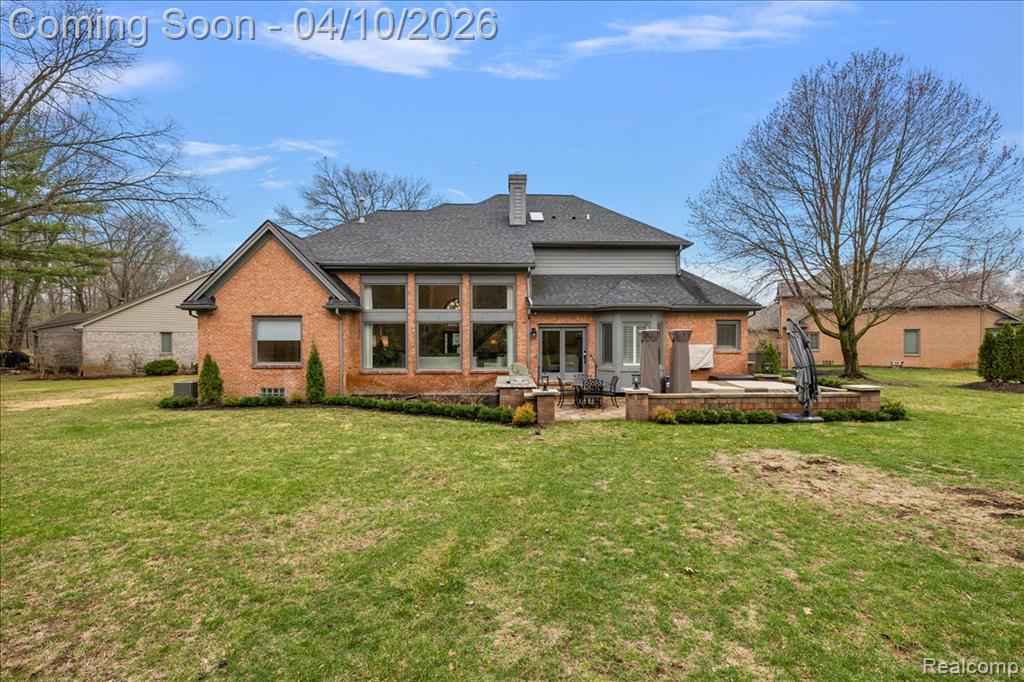 Rear Facade w/Beautiful Landscape, Paver Patio & Outdoor Kitchen