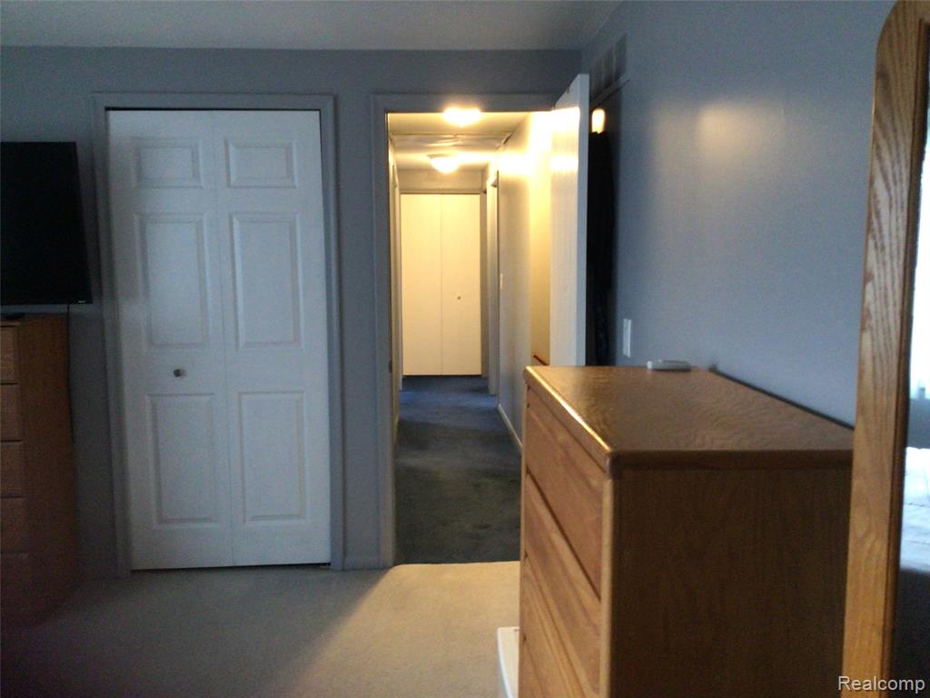 Unfurnished bedroom with carpet floors and a closet