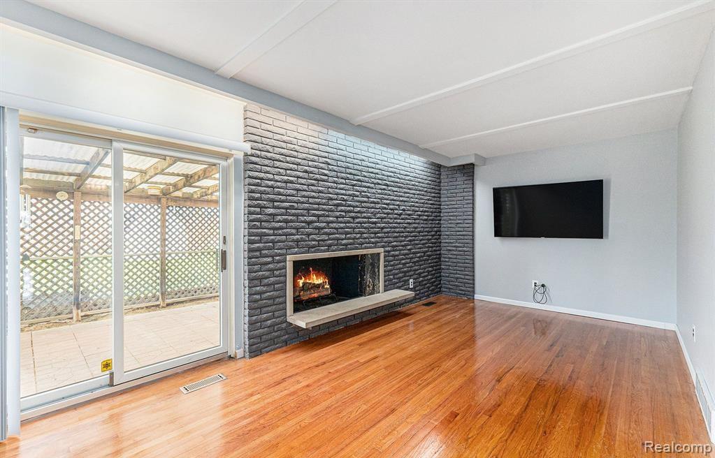 Unfurnished living room with a fireplace and light wood finished floors