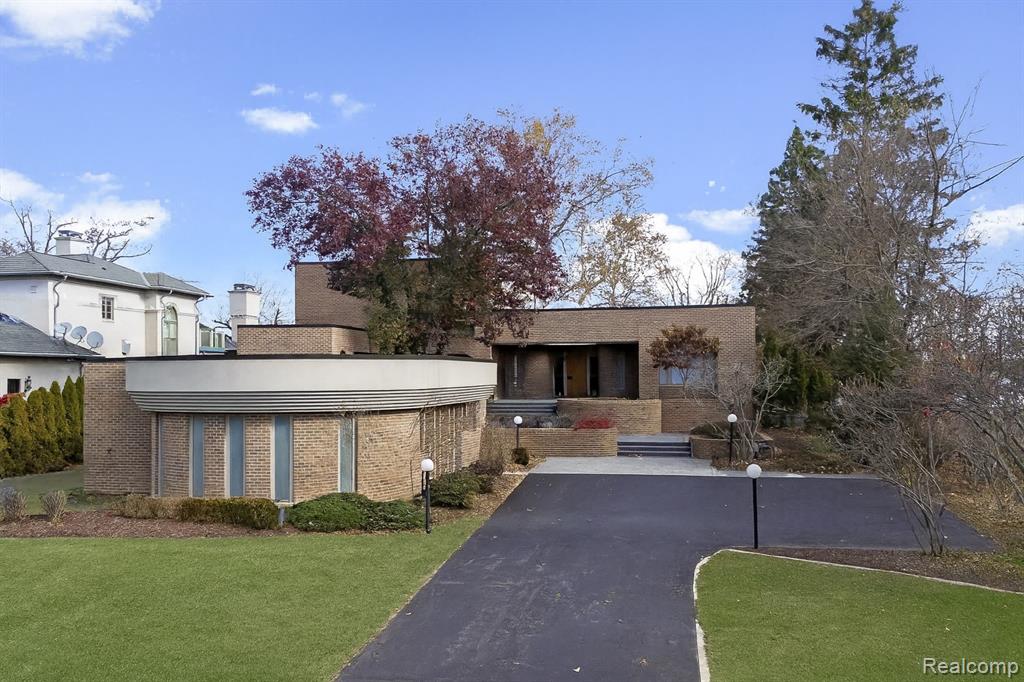 View of front of property with a front lawn and brick siding