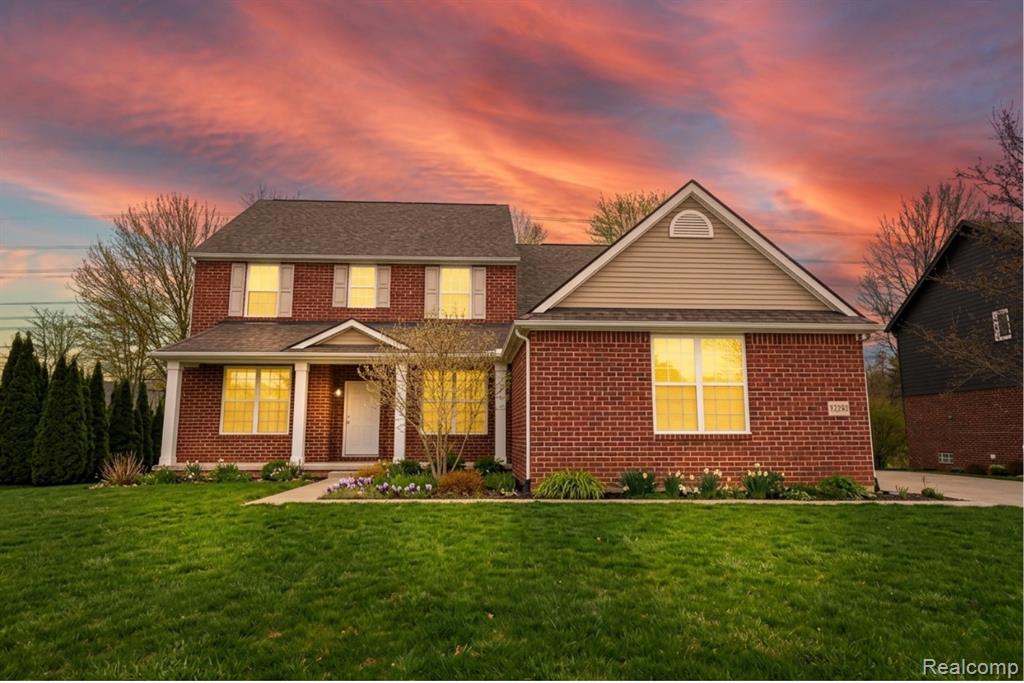 Dining area with light wood-style floors, stairs, and a tray ceiling