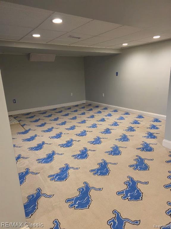 Finished below grade area featuring a paneled ceiling and recessed lighting