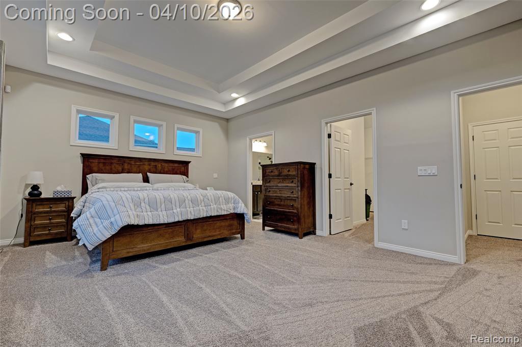 Bedroom with light colored carpet, recessed lighting, a spacious closet, and connected bathroom