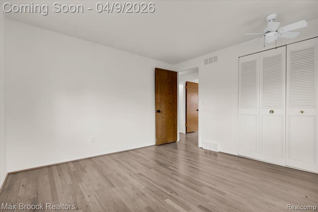 Unfurnished bedroom with light wood finished floors, a closet, and ceiling fan