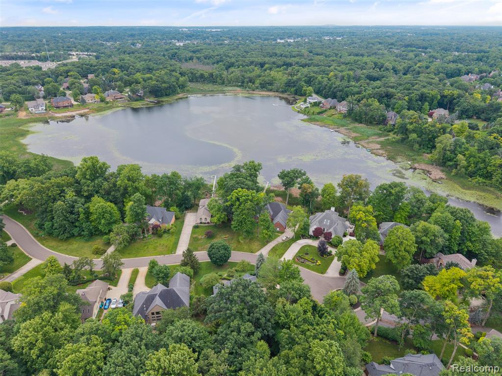 View of property location with a large body of water and nearby suburban area