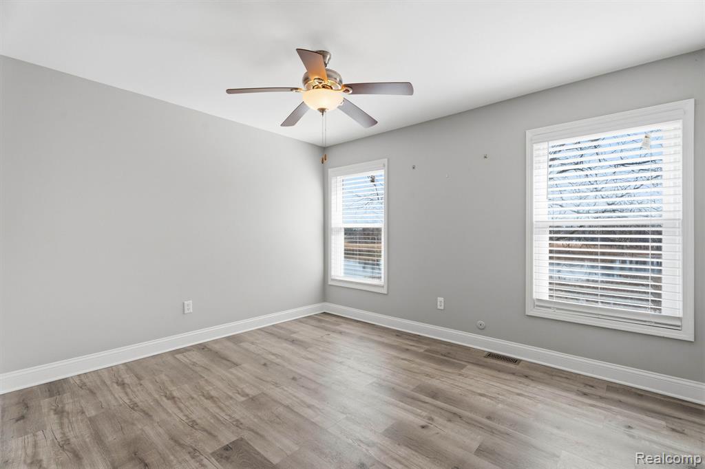 Spare room with ceiling fan and light wood-type flooring