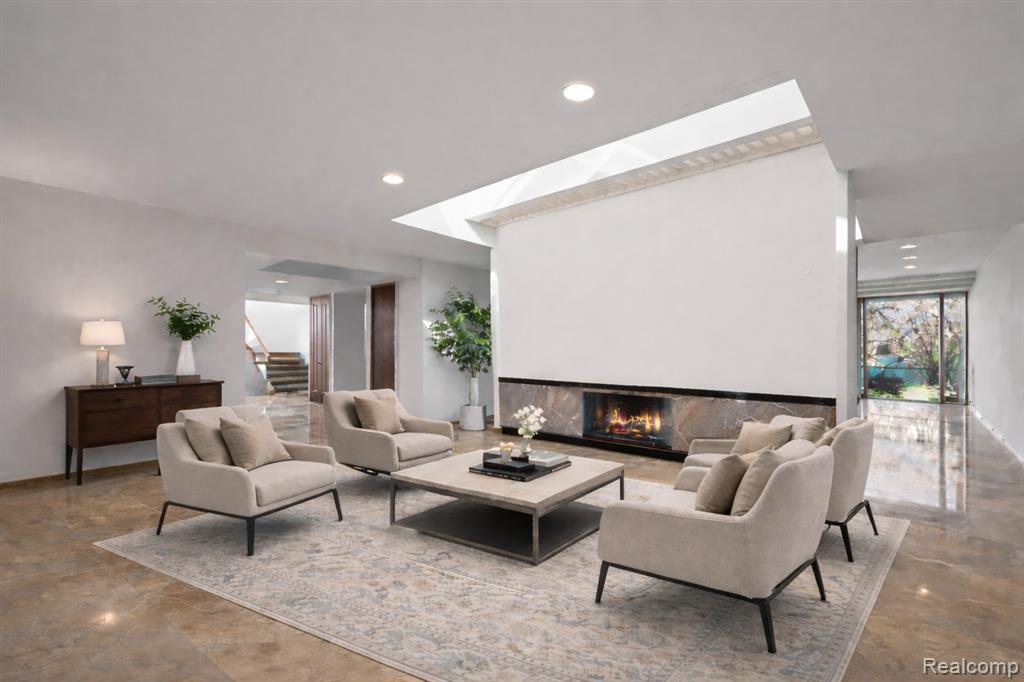 Foyer with recessed lighting, stairway, and a glass covered fireplace