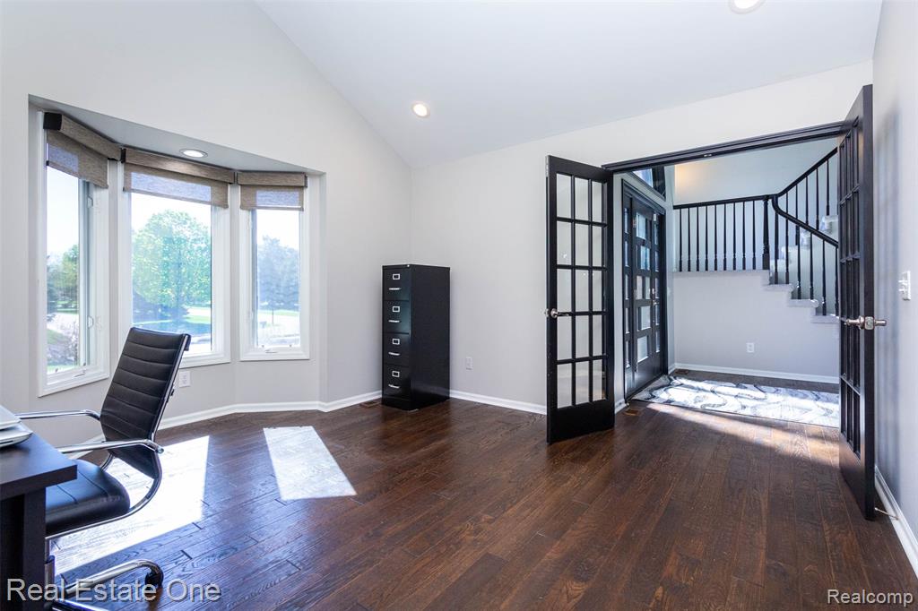 Library/Office featuring vaulted ceiling, hand scraped floors, French doors, bay window and recessed lighting