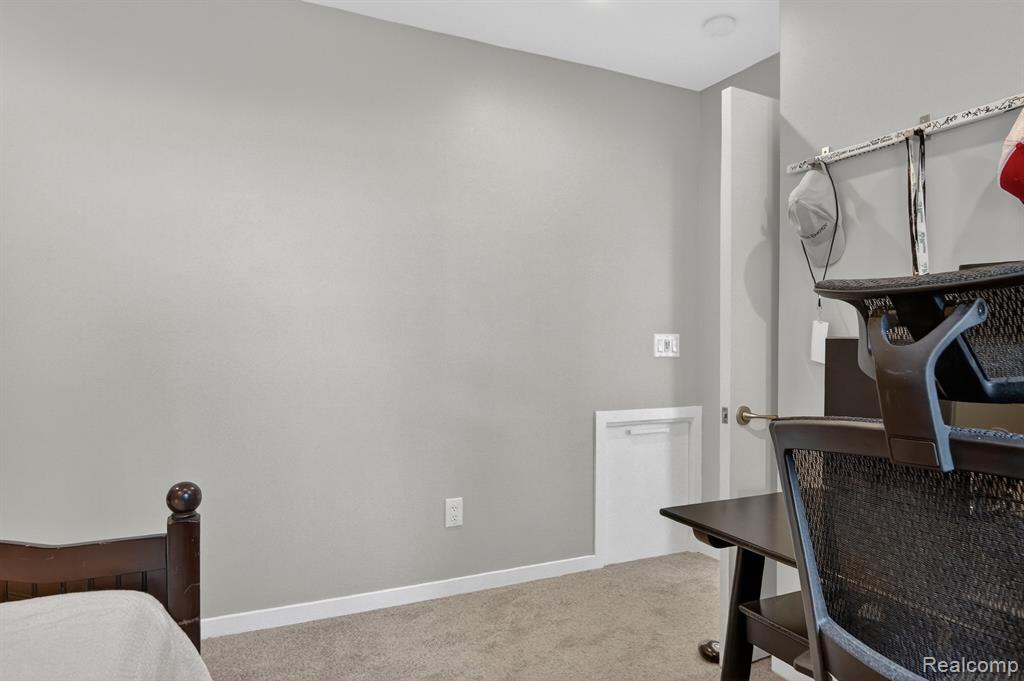 Bedroom featuring light colored carpet and baseboards