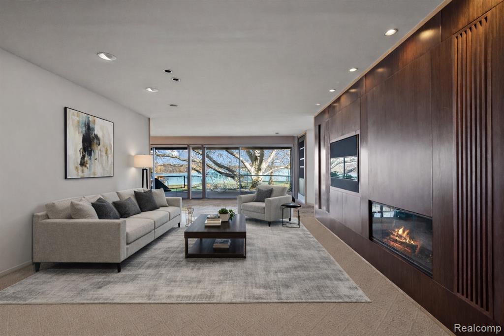 Living area with a glass covered fireplace and recessed lighting
