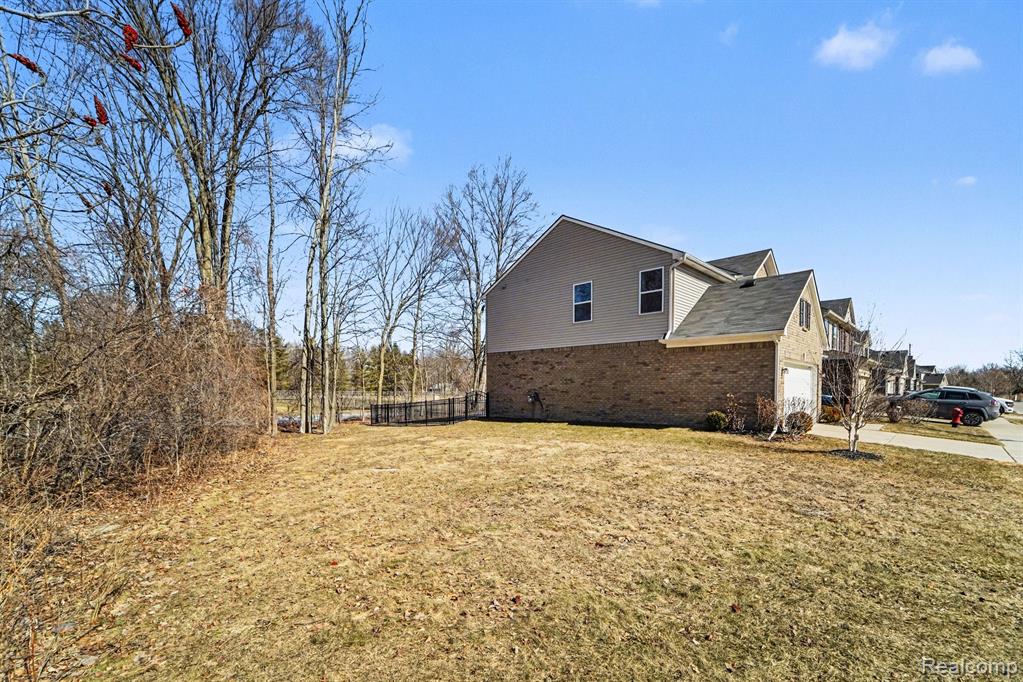 View of side of property featuring brick siding