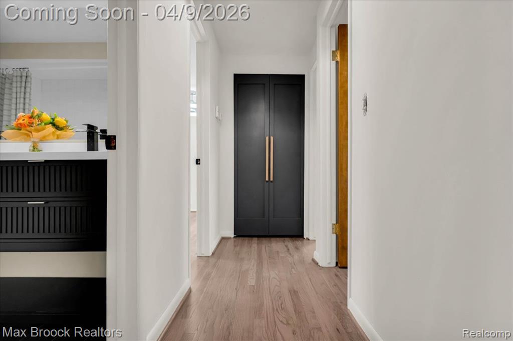 Hall with light wood finished floors and baseboards