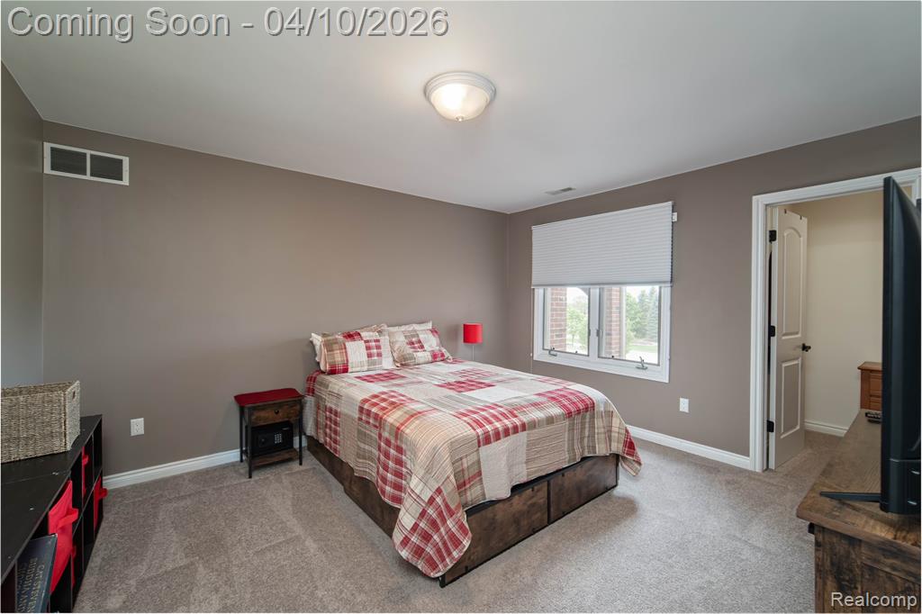 Bedroom with light carpet and baseboards