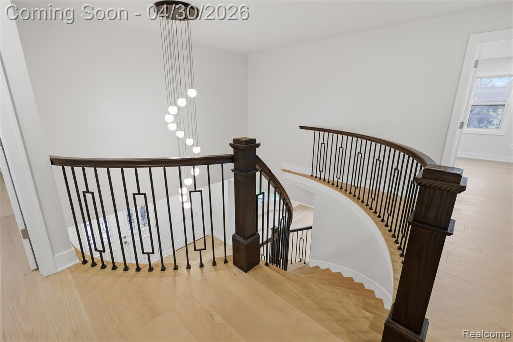 Stairway featuring wood finished floors and baseboards