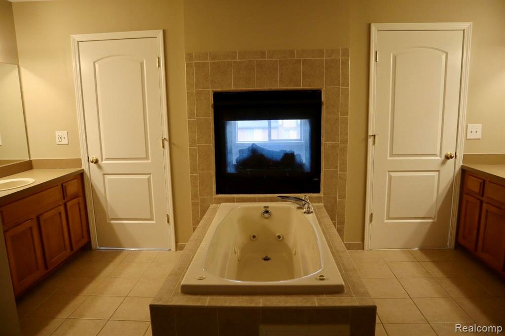Bathroom featuring a whirlpool tub and tile patterned floors