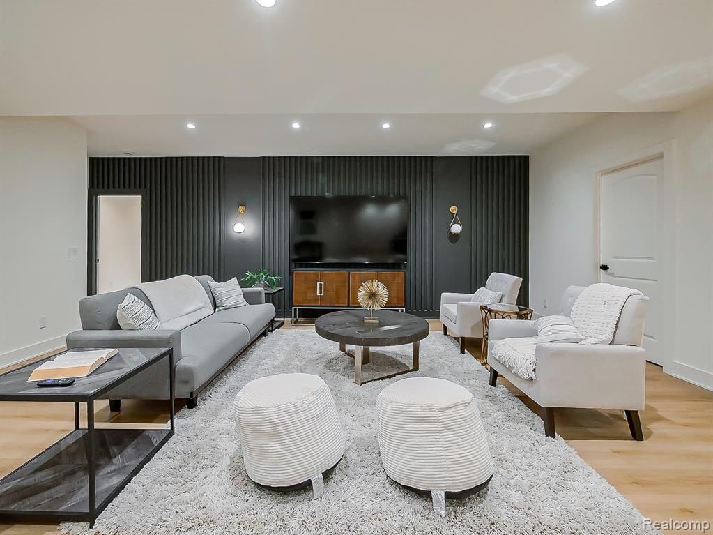 Living area featuring light wood-style floors and recessed lighting