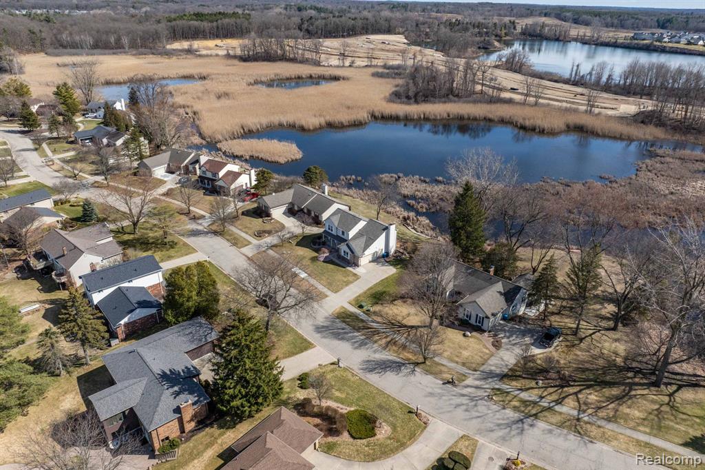 Aerial perspective of suburban area with a nearby body of water