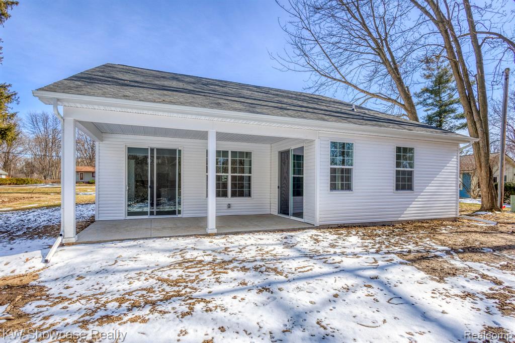 Back of property featuring a large covered patio.