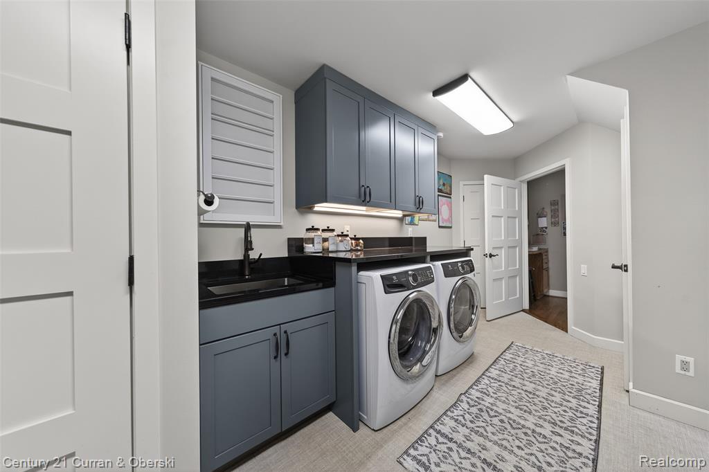 Laundry area featuring washing machine and dryer and cabinet space