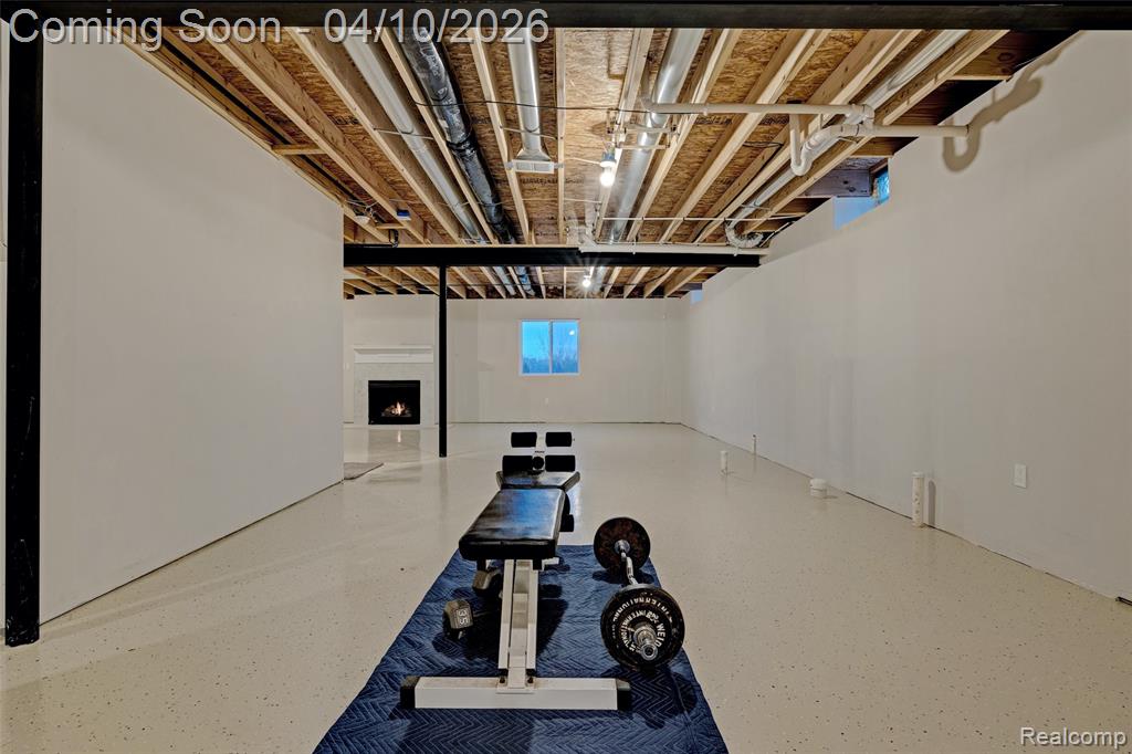 Below grade area with a lit fireplace
