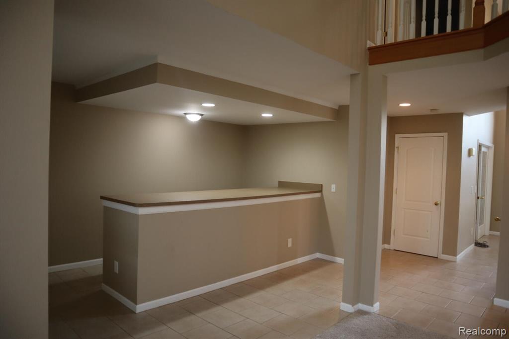 Below grade area featuring recessed lighting and light tile patterned floors