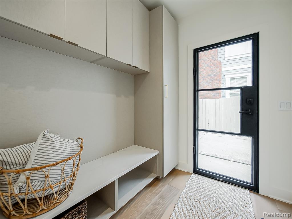 Mudroom with light wood-style flooring