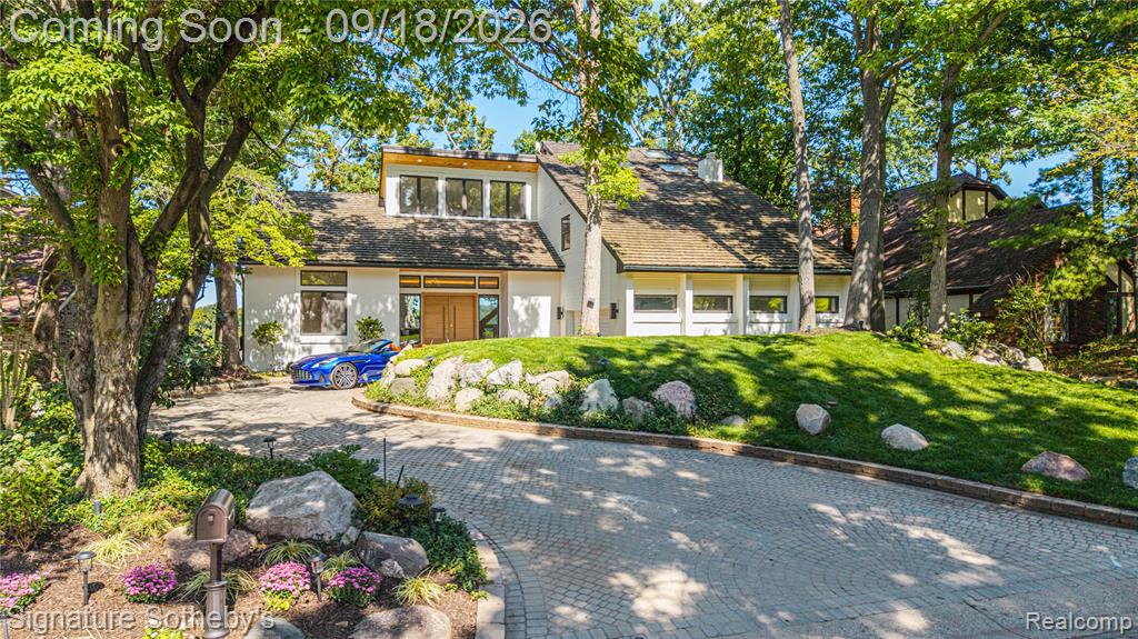 Contemporary exterior with white siding and a multi-level roofline