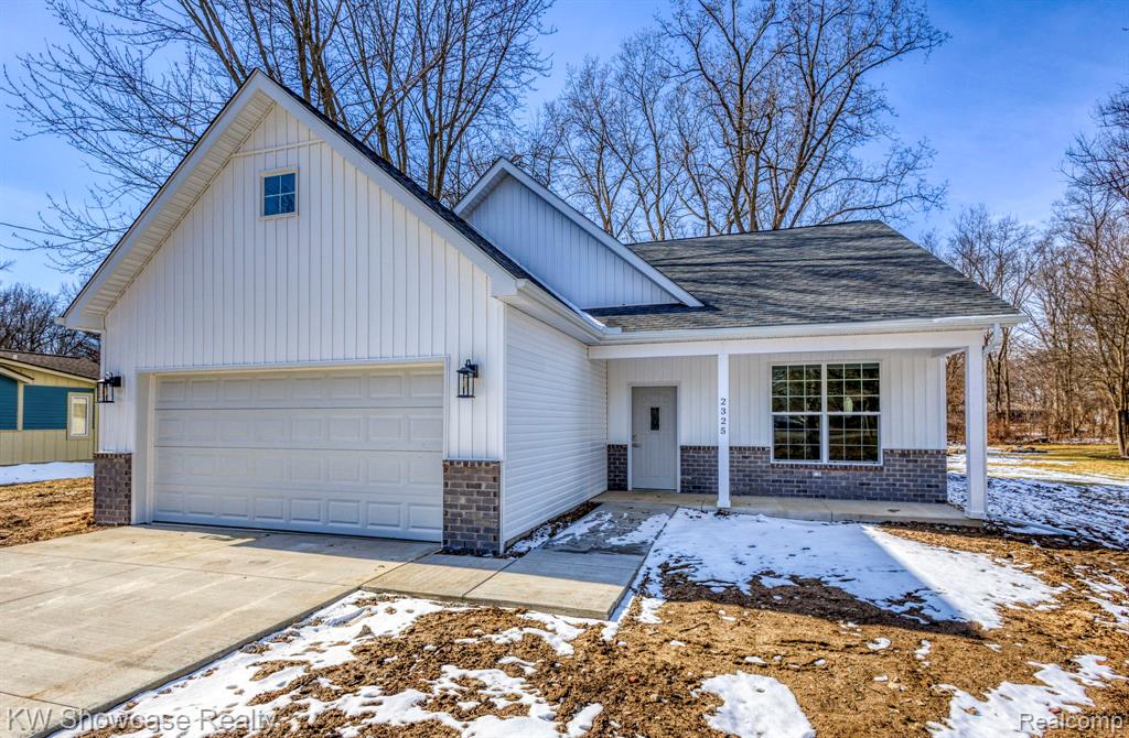 Side View of Structure Under Construction, with 20x10 Rear Covered Porch and Backyard.