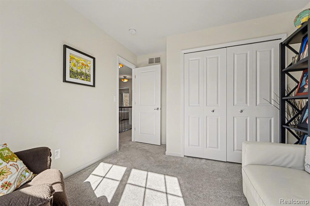 Living area with light colored carpet and baseboards